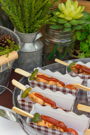 Chicken bbq in the tray, decorated and served on the table with green flowers, Close upの写真素材
