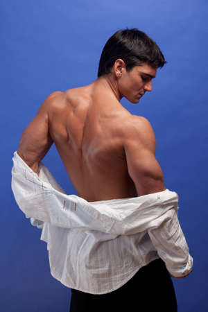 The sexy man poses for the photo.の写真素材