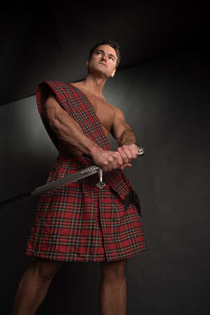 The handsome highlander poses for the photo.の写真素材