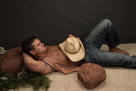 The sexy cowboy poses for the photo.の写真素材