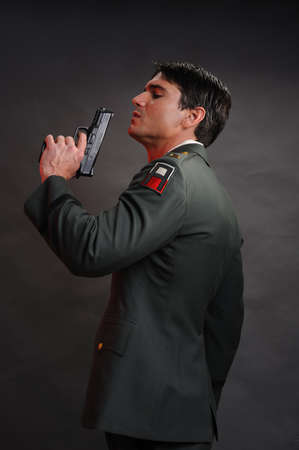 The sexy military man poses for the photo.