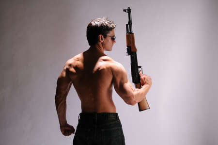 The sexy sniper poses for the photo.