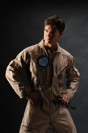 Portrait of a young soldier on a dark background. Studio shooting.