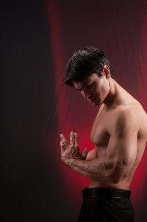 Portrait of a handsome young man with muscular body posing in studioの写真素材
