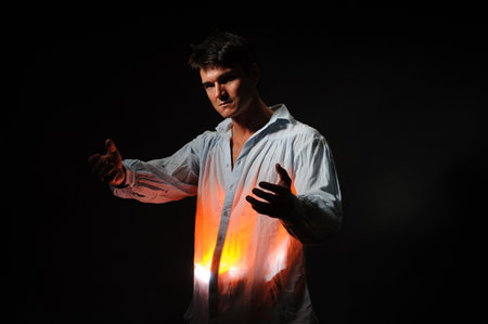 Portrait of a young man with a torch on a black background
