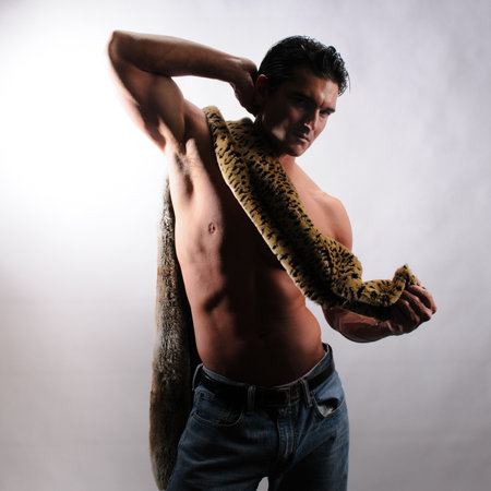 Handsome young man with muscular body posing in studio, looking at camera.の写真素材