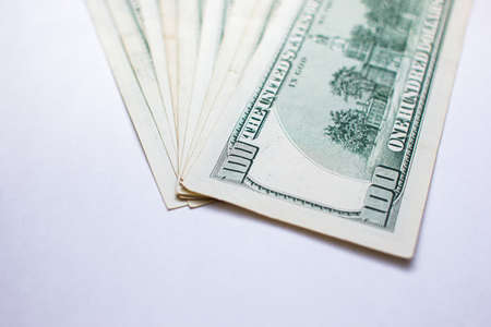One hundred dollar bills on a white background