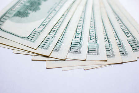 One hundred dollar bills on a white background