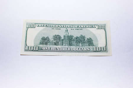One hundred dollar bills on a white background