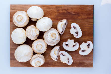 sliced mushrooms on a cutting boardの写真素材