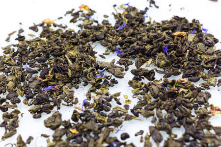 green tea leaves on a white background close up