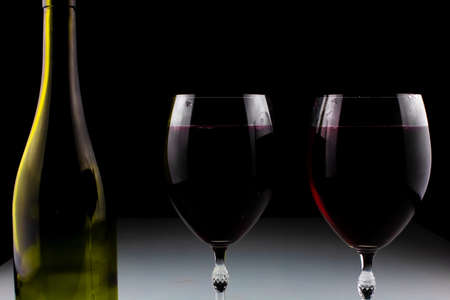 wine bottle and glass on black backgroundの写真素材