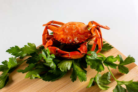 boiled crab on a cutting Board decorated with herbs