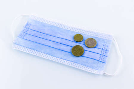 the coins are on the medical maskの写真素材