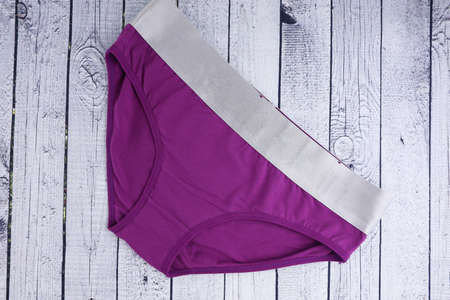women's underwear purple panties on a wooden background