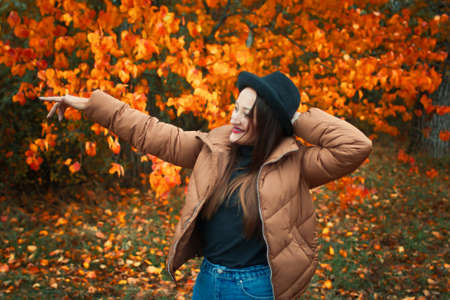 girl in a jacket and hat in autumn in the Park