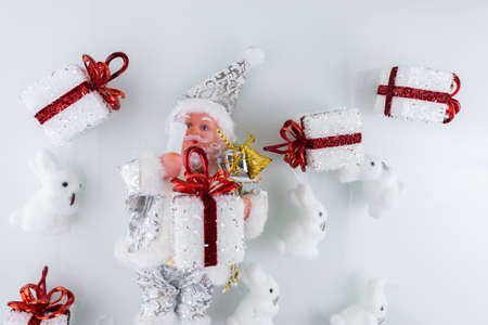 Santa's toy in white clothes and Christmas decorations on the Christmas treeの写真素材