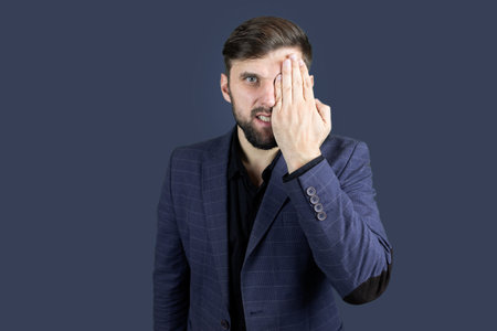a male businessman in a blue suit holds a laptopの写真素材