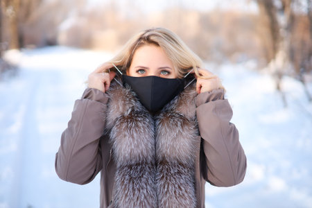 beautiful blonde in a jacket with a fur collarの写真素材