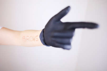 The girl shows one hand on which she makes the inscription browsの写真素材