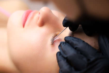 close-up of the model's eye with a curl of cilia the work is done lamination of eyelashes the master...
