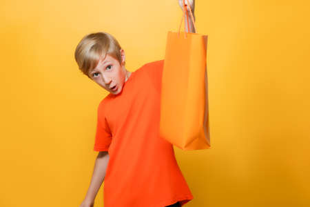 the child raised the package up and shows it in surpriseの写真素材