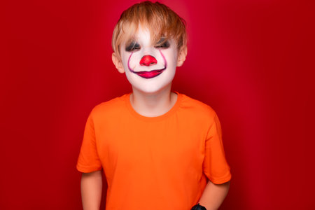 child with halloween makeup screwed up his eyes and looks at the camera.の写真素材