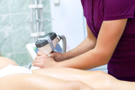 the master prepares the skin of the model for the procedure of vacuum massageの写真素材