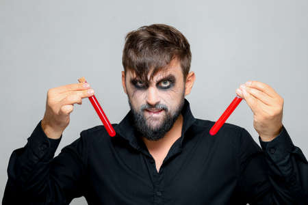 Portrait of a man with a beard and a menacing look with undead-style makeup on All Saints' Day on October 31の写真素材
