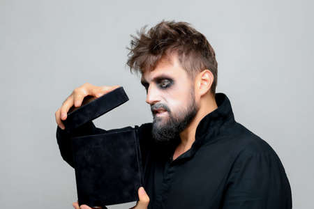 Portrait of a man with a beard and a menacing look with undead-style makeup on All Saints' Day on October 31の写真素材