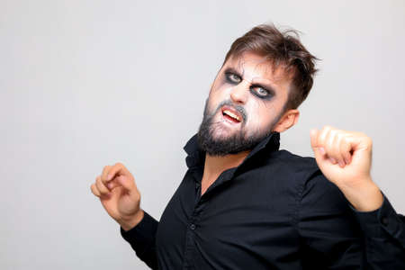 Portrait of a man with a beard and a menacing look with undead-style makeup on All Saints' Day on October 31の写真素材