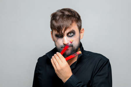 a man with a beard and makeup for Halloween grimacedの写真素材