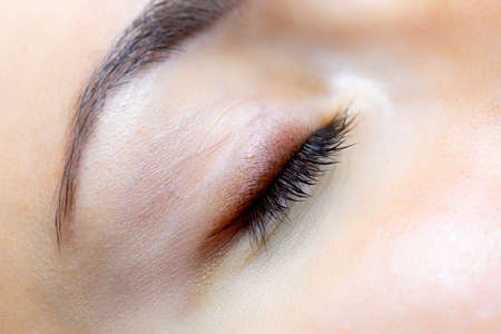 closed eye and completed work of permanent eyelid and eyelash makeupの写真素材