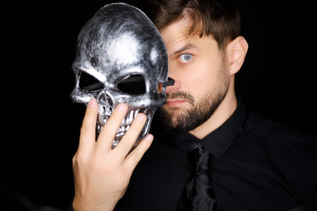 a man in a skeleton mask shows a variety of gestures with his hand