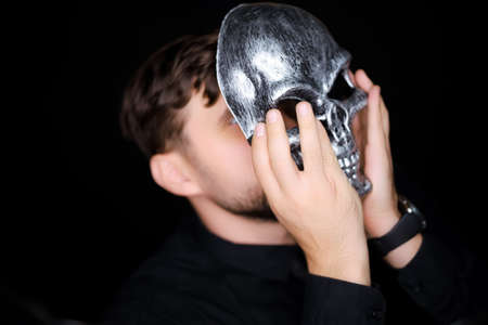a man in a skeleton mask shows a variety of gestures with his handの写真素材