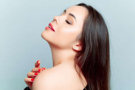 a young brunette girl closed her eyes and posed for the camera