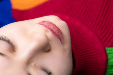 models after the first pass of permanent makeup, anesthesia is visible on the edges of the lips