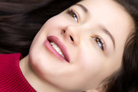 close-up of naked model girls and a ready-made permanent lip makeup procedure for her