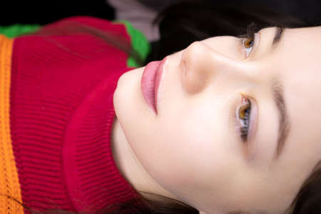 completed tattoo procedure a beautiful girl model is lying on a couch with permanent lip makeupの写真素材