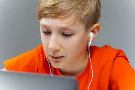 online learning at home boy sitting at laptops and typing