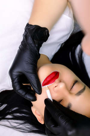 model with painted red lips before permanent lip makeup procedure