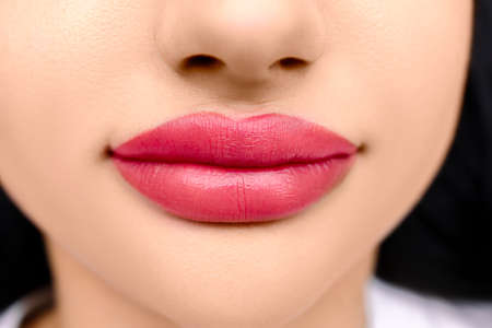 close-up of the lips of the model, the finished work of permanent makeup, the result after tattooingの写真素材