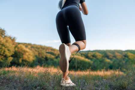 close-up of the shoes of a sports girl who stands with her back and performs exercises with an...