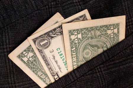 Dollar bills sticking out of your pocket.の写真素材