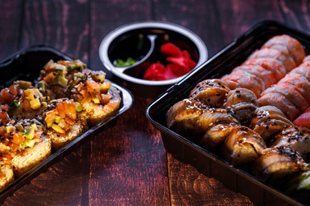 A set of delicious sushi rolls Sushi rolls with eel and salmon spread out on the table next to...