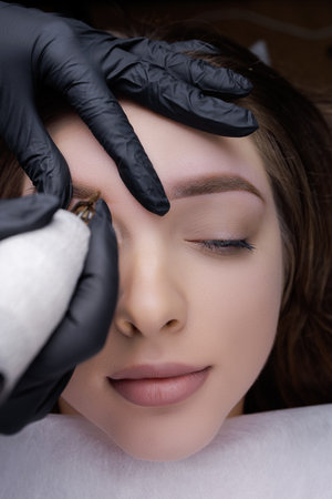 Result after permanent eyebrow makeup procedure in a beautiful girl. PMU Procedure, Permanent Eyebrow Makeup.の写真素材
