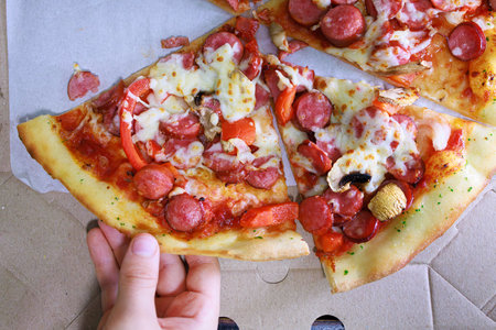 Appetizing slices of pizza Sausage and cheese pizza.