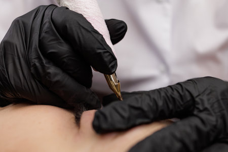 Close-up of the process of correction of permanent eyebrow makeup. Second PMU procedure in a month of permanent eyebrow makeup. Permanent makeup correction.の写真素材