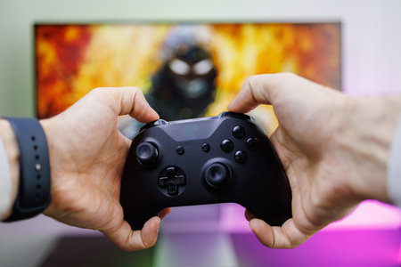 Holding the gamepad and using your fingers to press the top buttons on the gamepad. Video game...