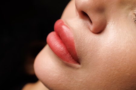 Sharp focus on lips with even tone and smooth skin, showing high-quality aesthetic procedure.の写真素材